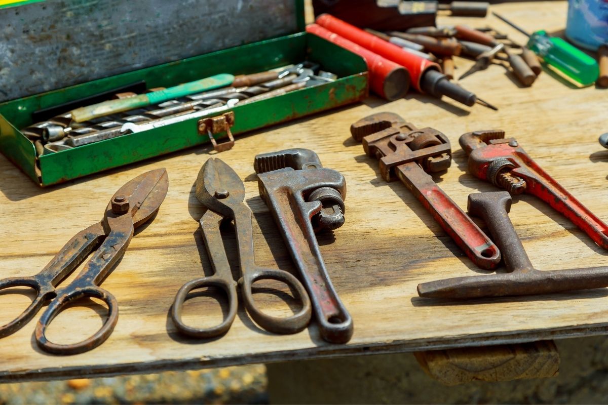A work table filled with various hand tools such as hammers, pliers, and screwdrivers, organized for easy access.